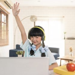 Asian girl using Laptop computer for online study homeschooling during home quarantine. online study, homeschooling, home quarantine, online learning or education technology concept.